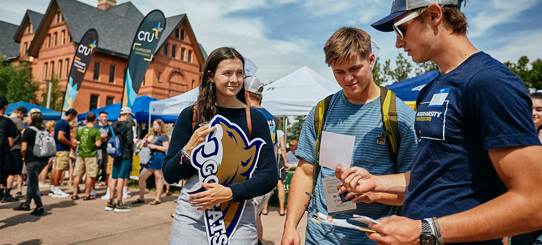 Students participating in an info fair outside