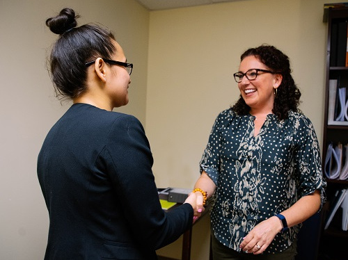 Student shaking hands with recruiter