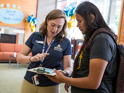 desk clerk helping a student