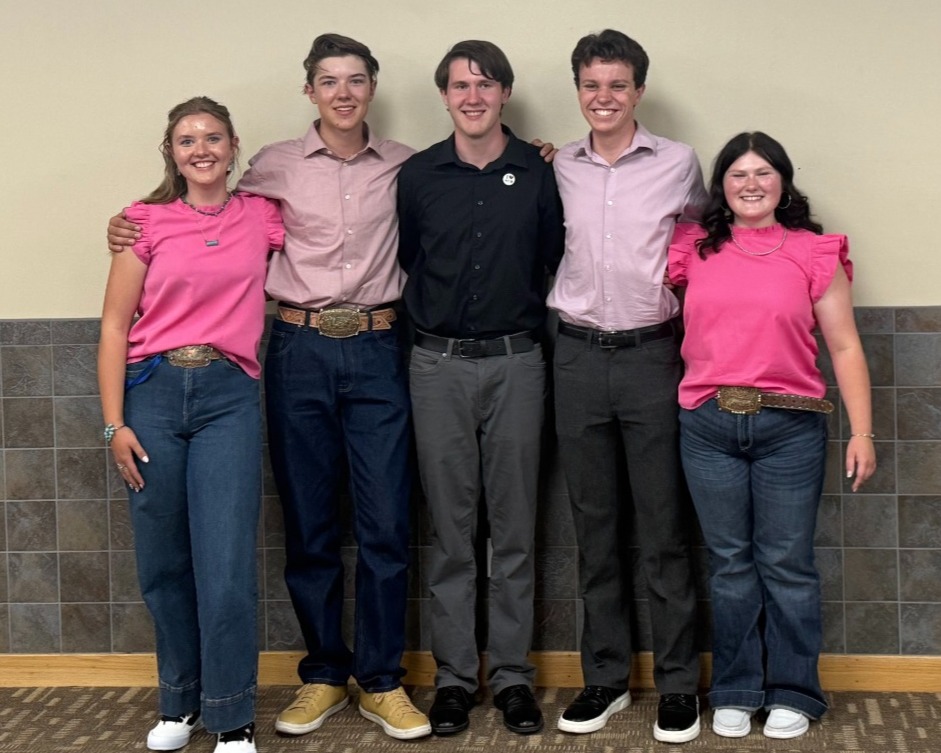 2024-2025 Ambassador Officer team stading in a line in front of stairs.