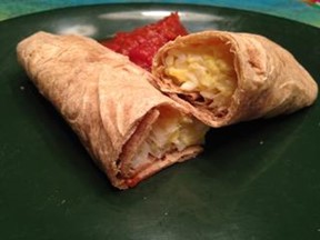 Two Breakfast Burritos on a plate with salsa.