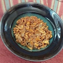 An image of skillet supper in a green bowl.