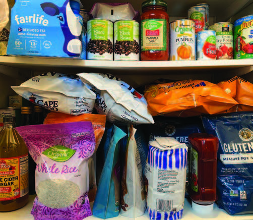 Pantry shelves are stocked with canned goods and bagged items.