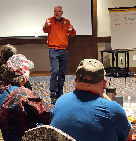a man teaching a workshop to a group of people