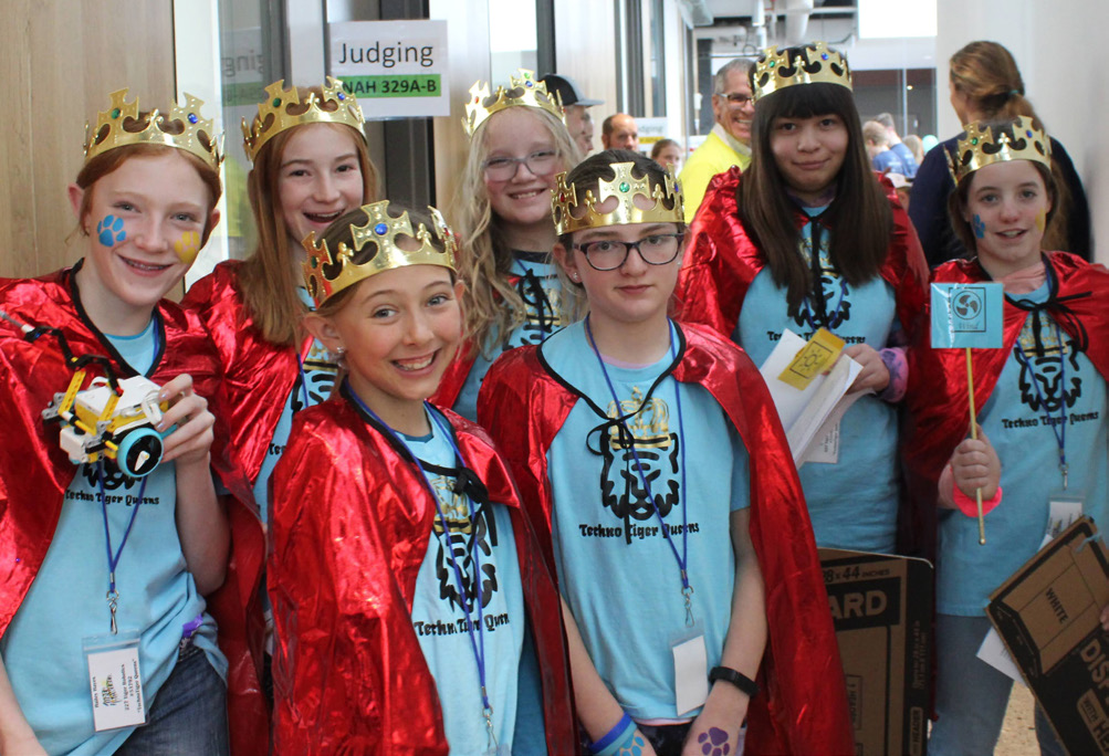 A team of robotics participants dressed as superheroes