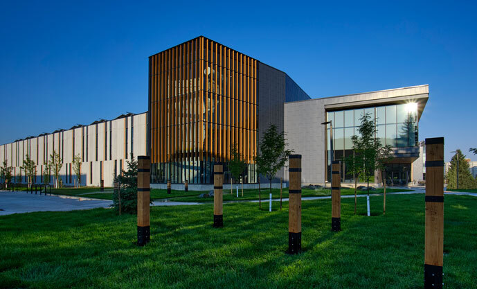 The new Student Wellness Center on a blue sky day with green grass in front.