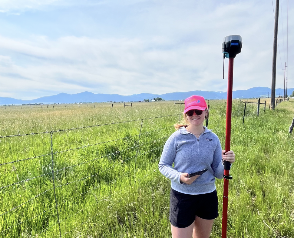 Woman holding the Emlid GPS Unit