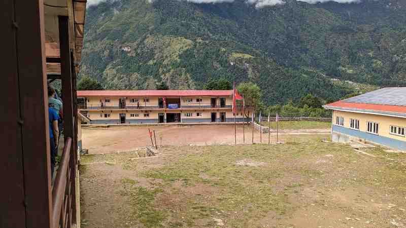 A view of buildings with mountains in the background.