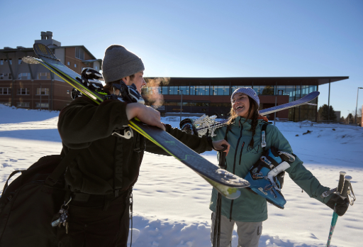 students leaving campus with skis