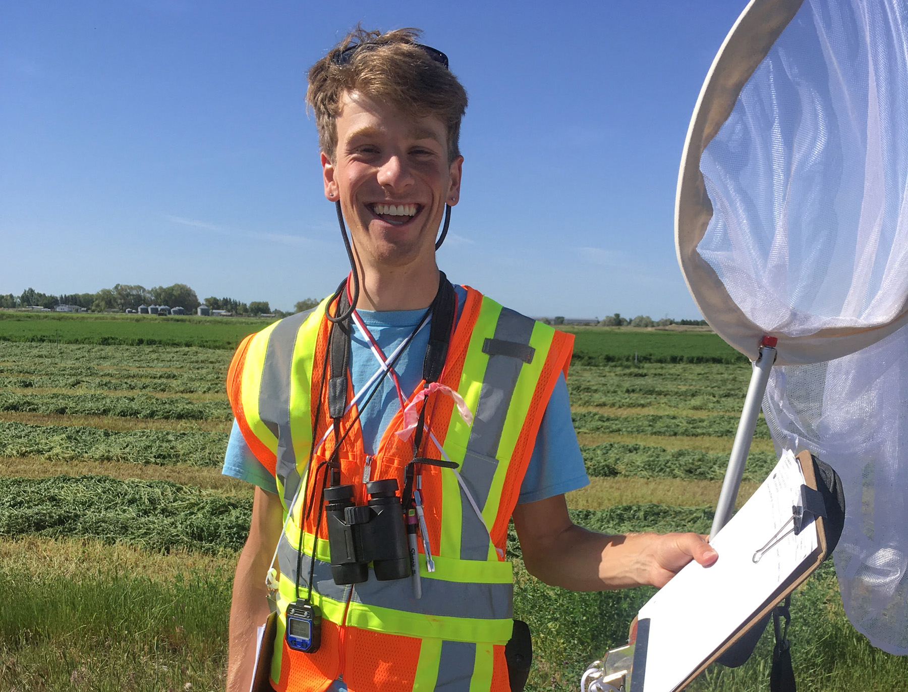 happy man with clipboard and butterfly net