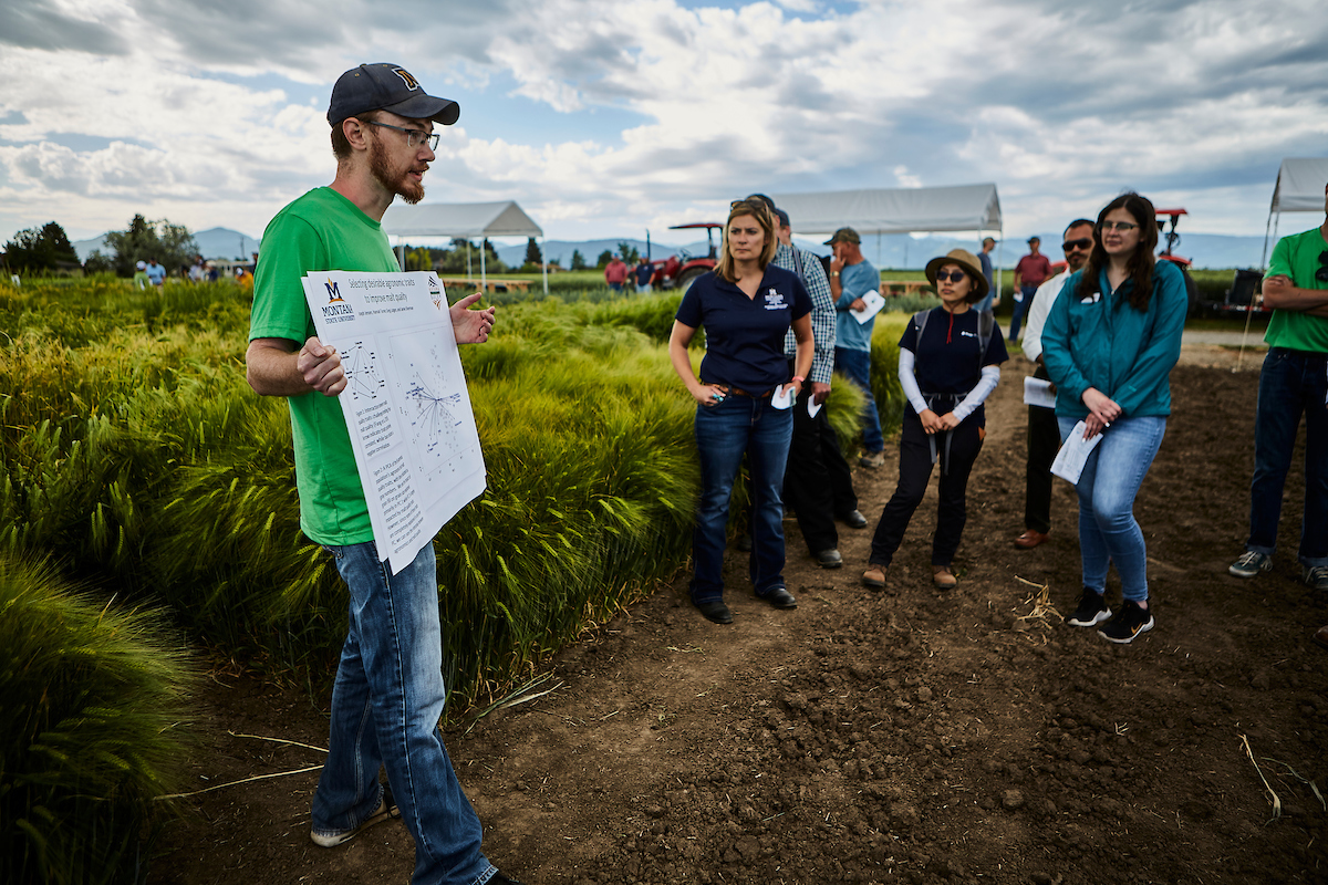 man in field with placard