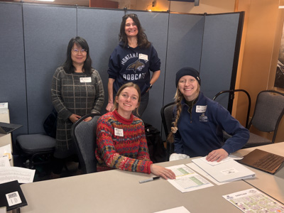 Science Olympiad supervisors standing around a table