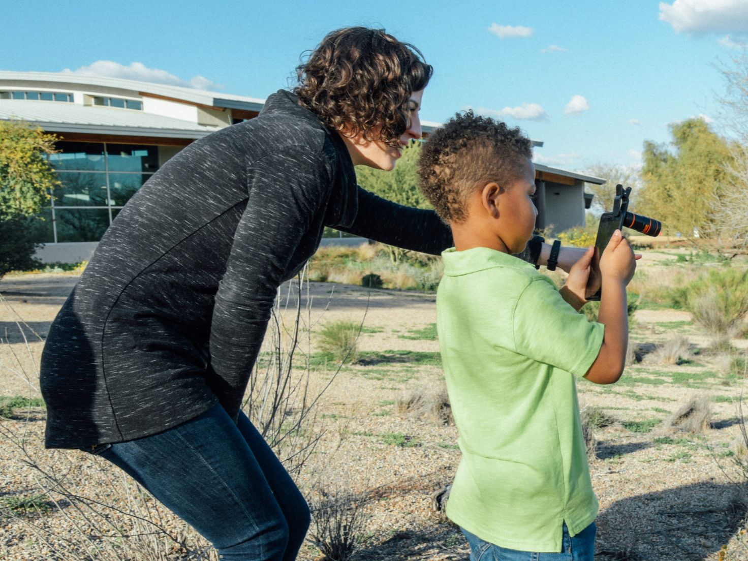 A Citizen Science instructor helping a child take a picture