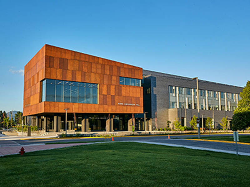A modern campus building with copper cladding.